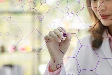 crop-unrecognizable-female-scientist-with-marker-writing-chemical-formulas-glass-board-while-working-with-colleagues-laboratory