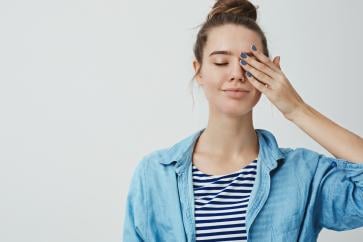 beautiful-teenage-woman-covering-one-eye-with-her-hand